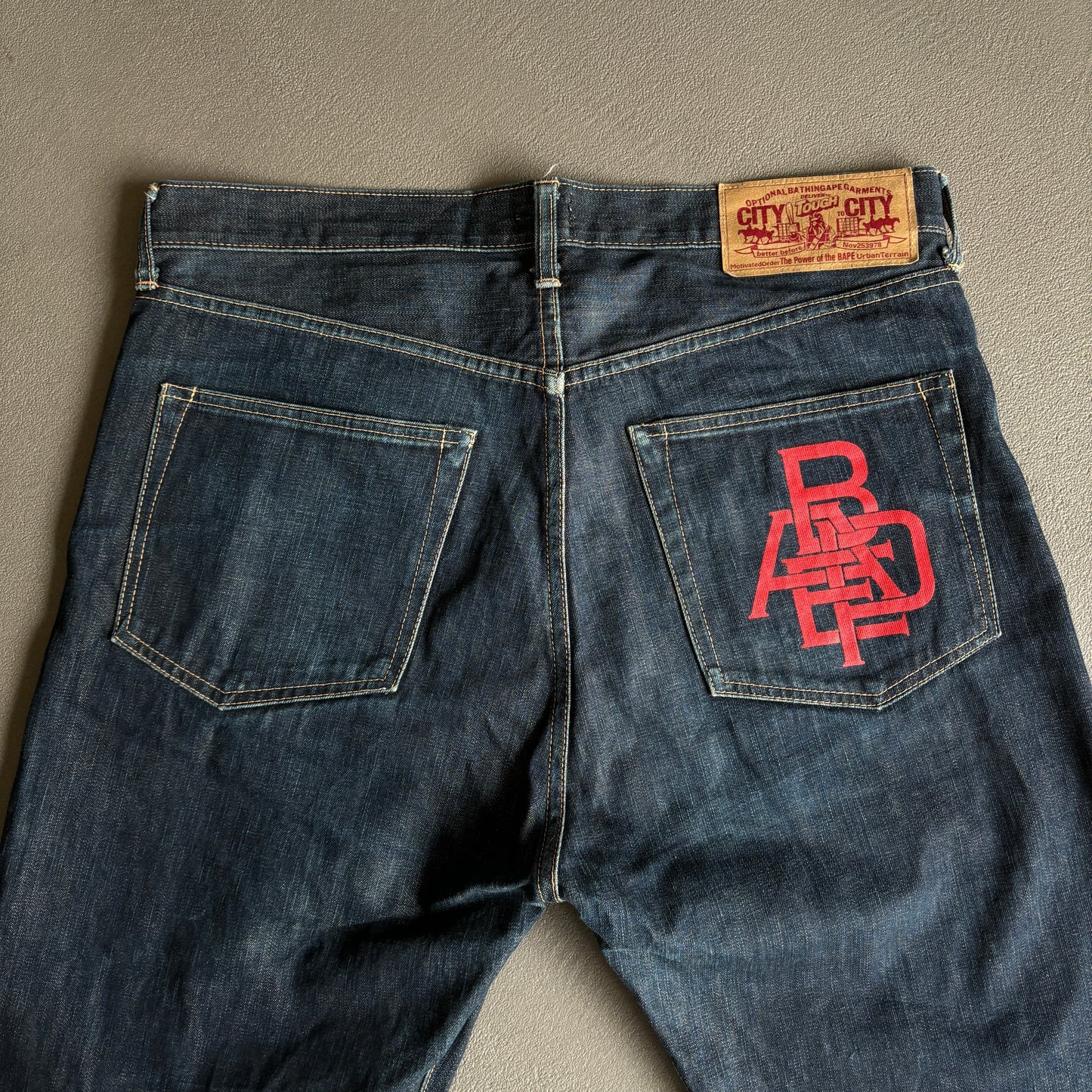 JEANS BAPE ROSSI CON LOGO E TASCA POSTERIORE [W32]